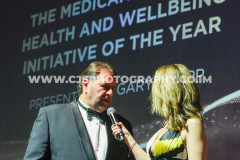Gary Whipp, Medicann with host Juliet Mann. Awards for Excellence 2025. Photo by Callum Staley (CJS Photography)