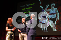 Nikki Arthur and Orran Smith recipients of the Special Achievement Award with host James Davis.  Isle of Man Sports Awards 2024. Photo by Callum Staley (CJS Photography)